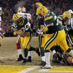  Green Bay Packers fullback John Kuhn (30) spikes the ball after making a touchdown run during the second half of an NFL wild-card playoff football game against the San Francisco 49ers, Sunday, Jan. 5, 2014, in Green Bay, Wis. (AP Photo/Mike Roemer)