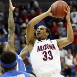 Arizona forward Jesse Perry (33) shoots as Memphis guard Antonio Barton defends during the first half of a West Regional NCAA tournament second round college basketball game, Friday, March 18, 2011 in Tulsa, Okla. (AP Photo/)