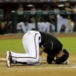 Arizona Diamondbacks' Martin Prado lies on the ground after fouling off a pitch on his leg against the Texas Rangers during the fifth inning of an inter league baseball game, Monday, May 27, 2013, in Phoenix. (AP Photo/Matt York)