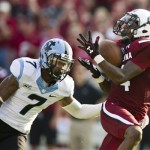 South Carolina wide receiver Shaq Roland (4) catches a touchdown pass while being defended by North Carolina cornerback Tim Scott (7) during the first half of an NCAA college football game, Thursday, Aug. 29, 2013, in Columbia, S.C. (AP Photo/Stephen Morton)
