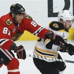 Chicago Blackhawks right wing Marian Hossa (81) battles for the puck against Boston Bruins left wing Brad Marchand (63) in the third period during Game 5 of the NHL hockey Stanley Cup Finals, Saturday, June 22, 2013, in Chicago. Chicago won 3-1. (AP Photo/Charles Rex Arbogast)
