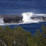 Waves crash as seen from the course before the first round at the Tournament of Champions PGA golf tournament, Sunday, Jan. 6, 2013, in Kapalua, Hawaii. Play was to have started two days earlier, but was delayed because of rain and high winds. (AP Photo/Elaine Thompson)