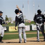  Seattle Mariners' Stefen Romero, left, celebrates his grand slam with teammate Kelly Shoppach (7) against the Kansas City Royals during the fourth inning of an exhibition spring training baseball game on Thursday, March 7, 2013, in Surprise, Ariz. (AP Photo/Marcio Jose Sanchez)