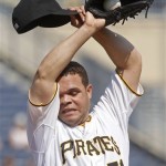 Pittsburgh Pirates starting pitcher Wandy Rodriguez wipes his face on his sleeve after giving up a double to Arizona Diamondbacks' Aaron Hill in the first inning of a baseball game on Thursday, Aug. 9, 2012, in Pittsburgh. (AP Photo/Keith Srakocic)
