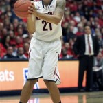  Arizona's Brandon Ashley (21) shoots for two of his 15 points against New Mexico State as Arizona's head coach Sean Miller watches in the background in the first half of an NCAA college basketball game on Wednesday, Dec. 11, 2013 in Tucson, Ariz. (AP Photo/John MIller)