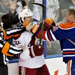  Phoenix Coyotes' Kyle Chipchura (24) is grabbed by Edmonton Oilers' Jesse Joensuu (6) as the referee tries to break them up during the second period of an NHL hockey game in Edmonton, Alberta, on Tuesday, Dec. 3, 2013. (AP Photo/The Canadian Press, Jason Franson)