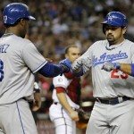 Los Angeles Dodgers' Adrian Gonzalez (23) is congratulated by Hanley Ramirez (13) after hitting a two-run home run against the Arizona Diamondbacks during the third inning of a baseball game, Tuesday, Sept. 17, 2013, in Phoenix. (AP Photo/Matt York)