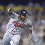 Atlanta Braves' Jose Constanza runs to first after hitting a single to score Elliot Johnson in the seventh inning of Game 4 in the National League baseball division series against the Los Angeles Dodgers, Monday, Oct. 7, 2013, in Los Angeles. (AP Photo/Mark J. Terrill)