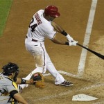 Arizona Diamondbacks' Chris Young (24) connects on a two-run home run as Pittsburgh Pirates' Rod Barajas looks on during the sixth inning in an MLB baseball game Monday, April 16, 2012, in Phoenix.(AP Photo/Ross D. Franklin)