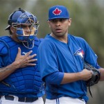 Toronto Blue Jays starting pitcher Ricky Romero, right, talks with Blue Jays catcher Henry Blanco, left, moments before being pulled against the Minnesota Twins during second inning of a spring training exhibition baseball game on Tuesday, Feb. 26, 2013, in Dunedin, Fla. (AP Photo/The Canadian Press, Nathan Denette)