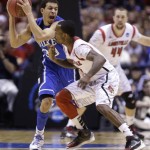 
Duke guard Seth Curry (30) tries to pass the ball against Louisville guard Russ Smith (2) during the first half of the Midwest Regional final in the NCAA college basketball tournament, Sunday, March 31, 2013, in Indianapolis. Duke won 85-63 to advance to the Final Four. (AP Photo/Michael Conroy)