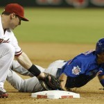 Arizona Diamondbacks' Paul Goldschmidt, left, applies a late tag to a diving Chicago Cubs' Darwin Barney in the ninth inning of a baseball game on Monday, July 22, 2013, in Phoenix. (AP Photo/Ross D. Franklin)