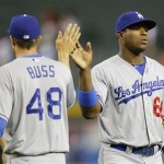 Los Angeles Dodgers' Yasiel Puig, right greets Nick Buss after their win over the Arizona Diamondbacks after a baseball game, Tuesday, Sept. 17, 2013, in Phoenix. The Dodgers won 9-3. (AP Photo/Matt York)