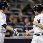 New York Yankees on-deck batter Lyle Overbay greets New Kevin Youkilis, right, after Youkilis scored on Eduardo Nunez's seventh-inning sacrifice fly in a baseball game against the Arizona Diamondbacks at Yankee Stadium in New York, Tuesday, April 16, 2013. (AP Photo/Kathy Willens)