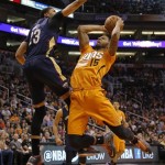  Phoenix Suns' Marcus Morris (15) shoots over New Orleans Pelicans' Anthony Davis (13) during the second half of an NBA basketball game, Friday, Feb. 28, 2014, in Phoenix. The Suns won 116-104. (AP Photo/Matt York)