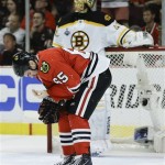 Chicago Blackhawks center Andrew Shaw (65) reacts after being hit in the face in the second period against the Boston Bruins during Game 5 of the NHL hockey Stanley Cup Finals, Saturday, June 22, 2013, in Chicago. (AP Photo/Nam Y. Huh)
