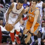 Los Angeles Clippers' Matt Barnes, left, moves with the ball next to Phoenix Suns' Goran Dragic, of Slovenia, in the second half of an NBA basketball game in Los Angeles, Saturday, Dec. 8, 2012. The Clippers won 117-99. (AP Photo/Jae C. Hong)
