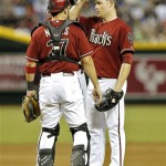 Arizona Diamondbacks pitcher Ian Kennedy, right, adjusts his cap while talking with catcher Wil Nieves against the Chicago Cubs during the fourth inning of a baseball game on Wednesday, July 24, 2013, in Phoenix. (AP Photo/Matt York)