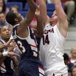 Duquesne's B.J. Monteiro, left, shoots over Arizona's Kyryl Natyazhko (14) during the first half of an NCAA college basketball game at the McKale Center, Wednesday, Nov. 9, 2011, in Tucson, Ariz. (AP Photo/John Miller)