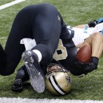 New Orleans Saints tight end Jimmy Graham (80) hits the ground after a touchdown reception over Carolina Panthers middle linebacker Luke Kuechly in the first half of an NFL football game in New Orleans, Sunday, Dec. 8, 2013. (AP Photo/Bill Haber)