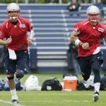 New England Patriots quarterbacks Tom Brady, left, and Tim Tebow run during a team football practice in Foxborough, Mass., Tuesday June 11, 2013. (AP Photo/Charles Krupa)
