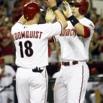 Arizona Diamondbacks' Paul Goldschmidt, right, celebrates with Willie Bloomquist (18) after hitting a two-run home run in the fifth inning during a baseball game against the Cincinnati Reds, Friday, June 21, 2013, in Phoenix. (AP Photo/Rick Scuteri)