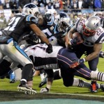New England Patriots' Stevan Ridley (22) runs for a tocuhdown as Carolina Panthers' Mike Mitchell (21) defends during the second half of an NFL football game in Charlotte, N.C., Monday, Nov. 18, 2013. (AP Photo/Mike McCarn)