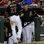 Arizona Diamondbacks' Wil Nieves (27) is greeted by manager Kirk Gibson after scoring on a double by teammate A.J. Pollock against the Texas Rangers during the second inning of an inter league baseball game, Monday, May 27, 2013, in Phoenix. (AP Photo/Matt York)