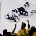 Chicago Blackhawks center Andrew Shaw lays on the ice after taking a puck to the face against the Boston Bruins during the first period in Game 6 of the NHL hockey Stanley Cup Finals, Monday, June 24, 2013, in Boston. (AP Photo/Charles Krupa)