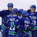 Vancouver Canucks defenseman Alexander Edler (23) celebrates his second period goal against the L.A. Kings with teammates Kevin Bieska, left to right, Maxim Lapierre, Ryan Kesler and Mason Raymond during NHL Stanley Cup playoff hockey action at Rogers Arena in Vancouver, British Columbia, Wednesday, April, 11, 2012. (AP Photo/The Canadian Press, Jonathan Hayward)
