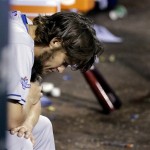 Los Angeles Dodgers starting pitcher Clayton Kershaw holds his head down in the dugout after being taken out of the game during the fifth inning of Game 6 of the National League baseball championship series against the St. Louis Cardinals, Friday, Oct. 18, 2013, in St. Louis. (AP Photo/David J. Phillip)