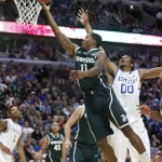 Michigan State guard Keith Appling (11) scores past Kentucky forward Marcus Lee during the second half of an NCAA college basketball game Tuesday, Nov. 12, 2013, in Chicago. Michigan State won 78-74. (AP Photo/Charles Rex Arbogast)