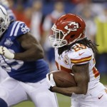 Kansas City Chiefs running back Jamaal Charles (25) runs as Indianapolis Colts defensive end Ricky Jean Francois (99) moves in during the first half of an NFL wild-card playoff football game Saturday, Jan. 4, 2014, in Indianapolis. (AP Photo/Darron Cummings)