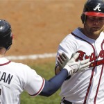 Atlanta Braves catcher Brian McCann, right, is congratulated by Freddie Freeman after hitting a solo home run against the St. Louis Cardinals in the seventh inning of a spring training baseball game in Kissimmee, Fla., Monday, March 19, 2012. (AP Photo/Paul Sancya)
