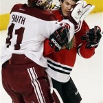  Phoenix Coyotes goalies Mike Smith, left, fights with Chicago Blackhawks' Andrew Shaw during the third period of an NHL hockey game in Chicago, Thursday, Nov. 14, 2013. The Blackhawks won 5-4. (AP Photo/Nam Y. Huh)