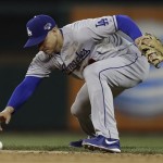 Los Angeles Dodgers' Mark Ellis has trouble with a ball hit by St. Louis Cardinals' Matt Carpenter during the fourth inning of Game 6 of the National League baseball championship series Friday, Oct. 18, 2013, in St. Louis. Ellis recovered to make the play. (AP Photo/Jeff Roberson)