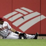 Arizona Diamondbacks center fielder Chris Young makes a sliding stop on a double by St. Louis Cardinals' Rafael Furcal in the third inning of a baseball game, Thursday, Aug. 16, 2012, in St. Louis. (AP Photo/Tom Gannam)