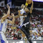Phoenix Suns' Diante Garrett (10) goes up for a shot against Golden State Warriors' Dwayne Jones, left, and Kent Bazemore in the fourth quarter of the NBA Summer League championship game, Monday, July 22, 2013, in Las Vegas. The Warriors won 91-77. (AP Photo/Julie Jacobson)