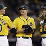  Oakland Athletics starting pitcher Sonny Gray, center, grimaces as he speaks with third baseman Josh Donaldson (20) and catcher Stephen Vogt (21) just before he was pulled from the game in the sixth inning of Game 5 of an American League baseball division series against the Detroit Tigers in Oakland, Calif., Thursday, Oct. 10, 2013. (AP Photo/Marcio Jose Sanchez)