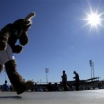 In this photo taken with a fisheye lens, the mascot for the Seattle Mariners walks along the concourse during an exhibition spring training baseball game against the San Diego Padres Friday, Feb. 22, 2013, in Peoria, Ariz. (AP Photo/Charlie Riedel)