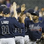 Atlanta Braves' Justin Upton, right, gets high-fives from teammates including Gerald Laird (11) after the ninth inning of a baseball game against the Arizona Diamondbacks, on Monday, May 13, 2013, in Phoenix. The Braves beat the Diamondbacks 10-1. (AP Photo/Ross D. Franklin)
