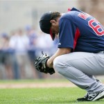 Boston Red Sox starting pitcher Steven Wright kneels during the second inning of a spring training baseball game against the Toronto Blue Jays in Dunedin, Fla., on Monday, Feb. 25, 2013. (AP Photo/The Canadian Press, Nathan Denette)