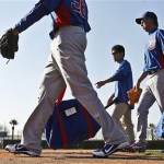 Chicago Cubs' Kyuji Fujikawa, right, of Japan, walks with interpreter Ryo Shinkawa, second from right, and teammates Matt Garza, left, and Edwin Jackson as they head to a practice field during a spring training baseball workouts for pitchers and catchers Tuesday, Feb. 12, 2013, in Mesa, Ariz.(AP Photo/Ross D. Franklin)