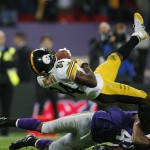 Pittsburgh Steelers wide receiver Antonio Brown (84) is brought down by Minnesota Vikings safety Mistral Raymond during the second half of their NFL football game at Wembley Stadium, London, Sunday,Sept. 29, 2013. The Vikings defeated the Steelers 34-27. (AP Photo/Matt Dunham)