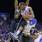 Duke guard Rasheed Sulaimon grabs a rebound in front of Michigan State forward Adreian Payne during the second half of a regional semifinal in the NCAA college basketball tournament, Friday, March 29, 2013, in Indianapolis. (AP Photo/Darron Cummings)