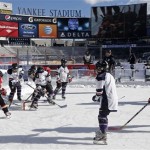  Youngsters from various NHL diversity teams use the practice ice before an NHL outdoor hockey game between the New York Rangers and the New Jersey Devils at Yankee Stadium in New York, Sunday, Jan. 26, 2014. (AP Photo/Kathy Willens)
