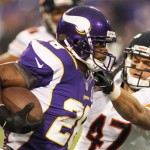 Minnesota Vikings running back Adrian Peterson, left, tries to break a tackle by Chicago Bears safety Chris Conte during the first half of an NFL football game Sunday, Dec. 9, 2012, in Minneapolis. (AP Photo/Andy King)