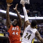 Atlanta Hawks forward Ivan Johnson (44) shoots over Indiana Pacers forward Paul George in the first half of Game 2 of a first-round NBA basketball playoff series in Indianapolis, Wednesday, April 24, 2013. (AP Photo/Michael Conroy)