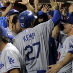 Los Angeles Dodgers Matt Kemp (17) is greeted in the dugout after scoring on a two-run home run by Juan Uribe during the first inning of a baseball game against the Arizona Diamondbacks, Tuesday, Sept. 17, 2013, in Phoenix. (AP Photo/Matt York)