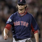 Boston Red Sox starting pitcher Clay Buchholz walks to the dugout after keeping the Minnesota Twins scoreless through the second inning in a spring training baseball game Monday, March 5, 2012, in Fort Myers, Fla. (AP Photo/David Goldman)